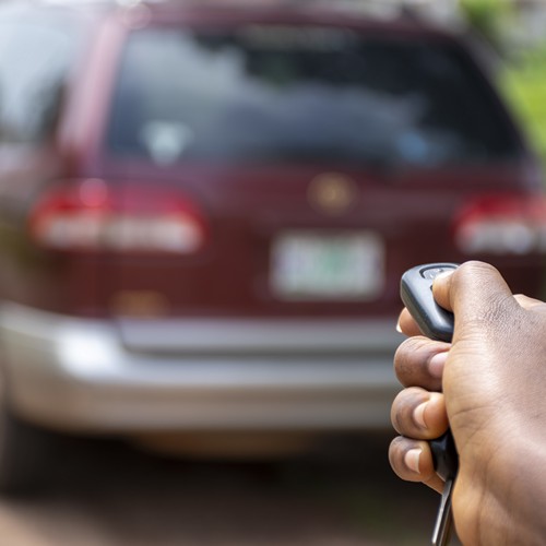 Technician programming a car remote key in Charleston